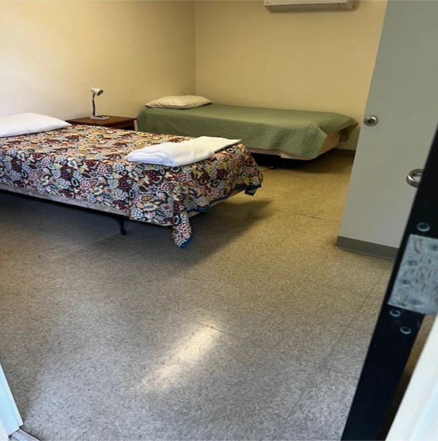 Room with two beds and window view